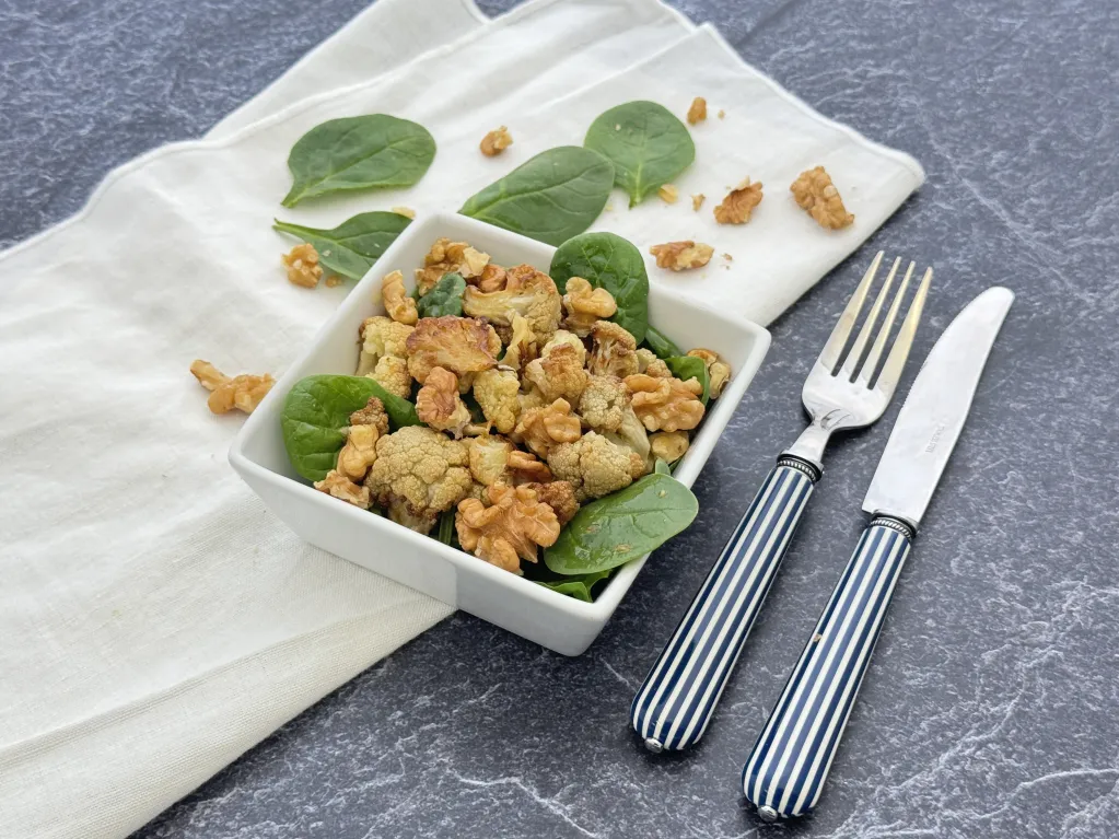 salade de chou-fleur grillé, pousses d'épinard et noix